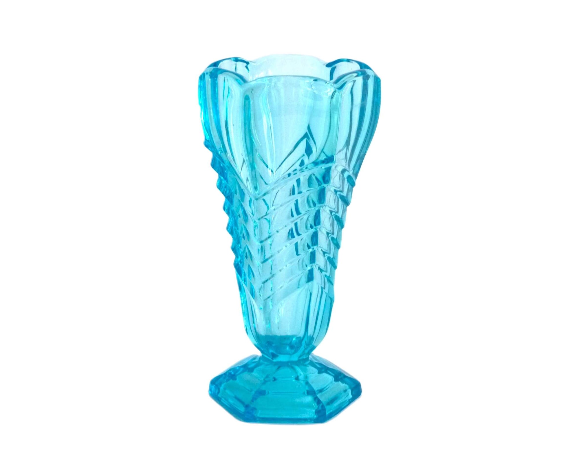 A deep teal blue coloured vase with an Art Deco Chevron  design cut into the glass around the body of the vase.