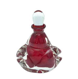 A deep burgundy and clear glass perfume bottle with a clear glass stopper.