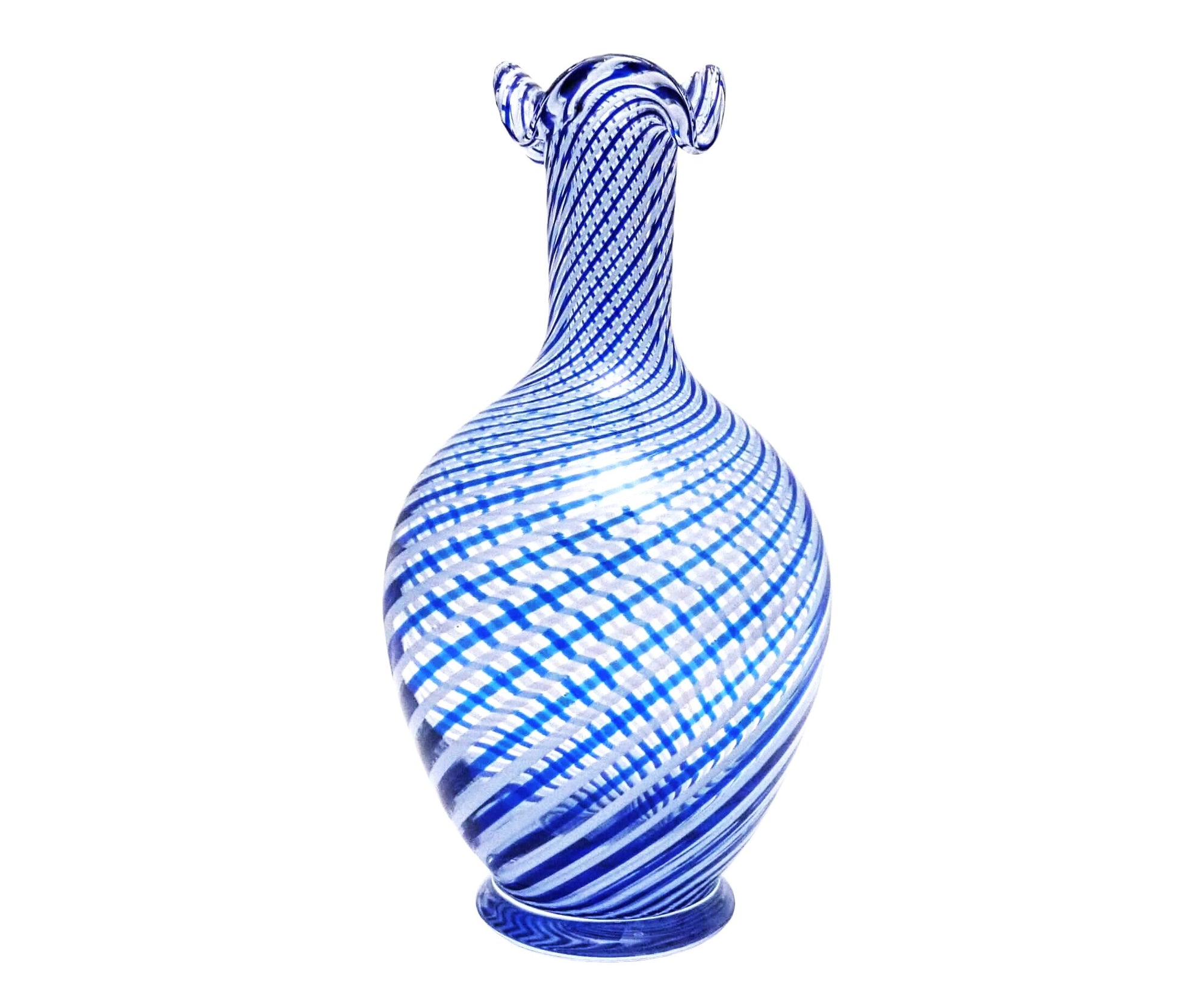 The glass vase has a bulbous bottom tapering to a thin neck  with a frilled opening. The stripes swirling around the vase are alternating dark blue and white.