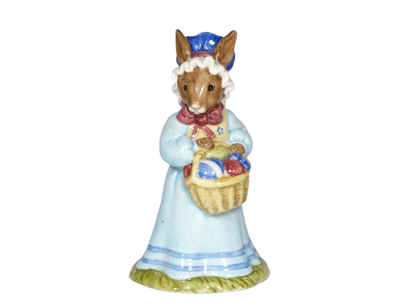 Mrs Bunnykins is wearing a pale blue dress, a dark blue bonnet with a white frill and a big pink bow. She is carrying a cane basket of Easter eggs.