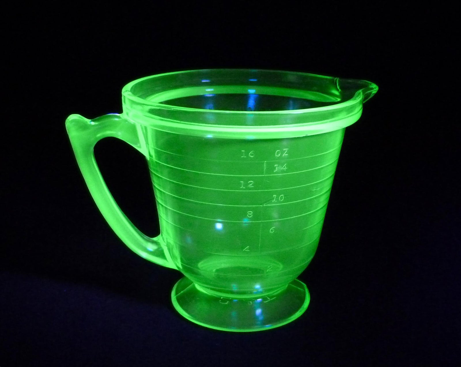 Brightly glowing green uranium glass measuring jug. 2 cup/ 1 pint.