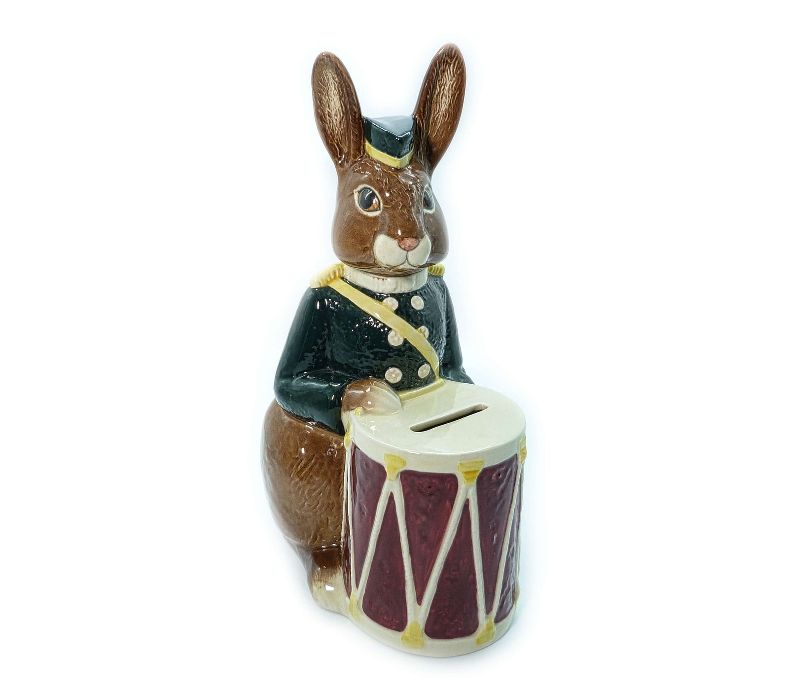 Dressed in a green military jacket and hat with a drum moneybox.